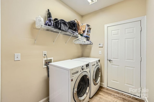 5832 Lagrande Dr, Charlotte, NC 28269 - washroom featuring washing machine and dryer, baseboards, and light wood-style floors