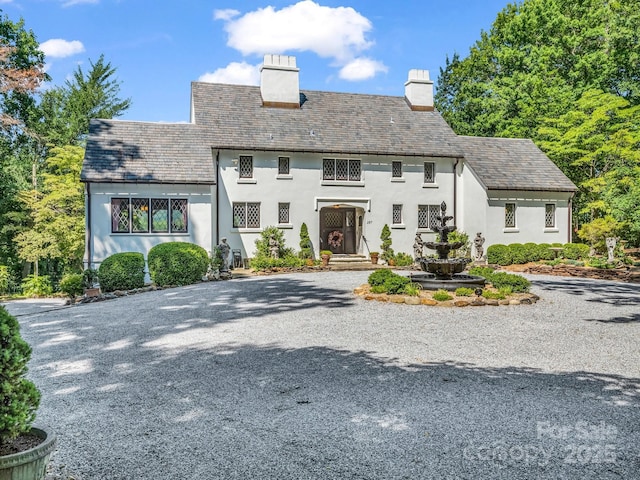 287 Pacolet Ridge Ln, Tryon, NC 28782 - tudor-style house with a chimney, driveway, a high end roof, and stucco siding