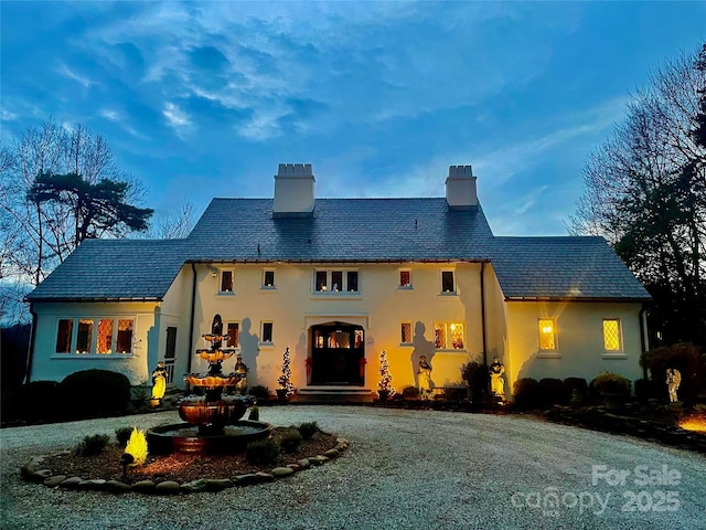 287 Pacolet Ridge Ln, Tryon, NC 28782 - back of house featuring a high end roof, a chimney, stucco siding, and curved driveway