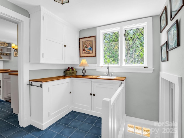 287 Pacolet Ridge Ln, Tryon, NC 28782 - kitchen featuring dark tile patterned floors, wooden counters, and white cabinetry
