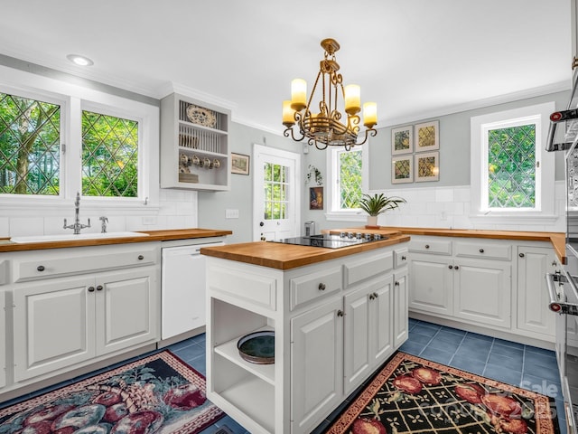 287 Pacolet Ridge Ln, Tryon, NC 28782 - kitchen with butcher block countertops, white dishwasher, open shelves, dark tile patterned flooring, and ornamental molding
