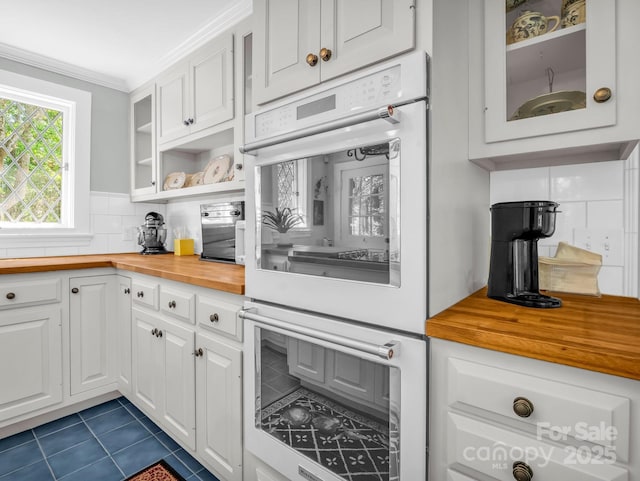 287 Pacolet Ridge Ln, Tryon, NC 28782 - kitchen with wood counters, white double oven, dark tile patterned flooring, white cabinets, and glass insert cabinets