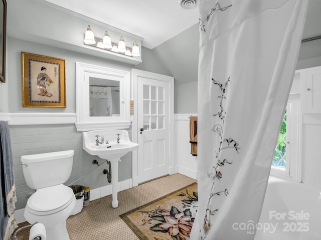 287 Pacolet Ridge Ln, Tryon, NC 28782 - full bath with wainscoting, vaulted ceiling, tile patterned flooring, and tile walls