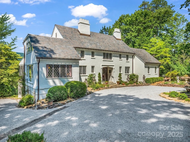 287 Pacolet Ridge Ln, Tryon, NC 28782 - english style home with a chimney, a high end roof, gravel driveway, and stucco siding
