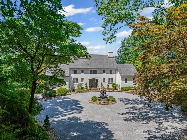 287 Pacolet Ridge Ln, Tryon, NC 28782 - view of front facade featuring curved driveway, stucco siding, and a chimney