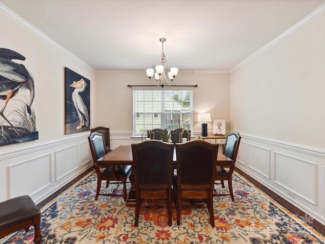 8035 Pastime Ln, Clover, SC 29710 - dining area with wood finished floors, a chandelier, crown molding, a decorative wall, and wainscoting