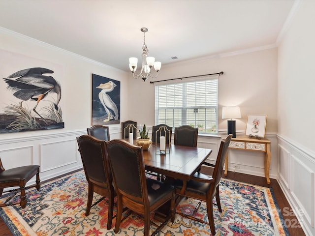 8035 Pastime Ln, Clover, SC 29710 - dining space with a chandelier, wood finished floors, crown molding, wainscoting, and a decorative wall