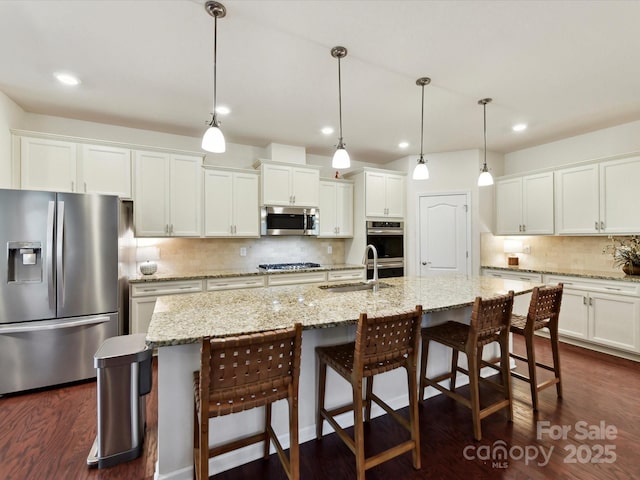8035 Pastime Ln, Clover, SC 29710 - kitchen with appliances with stainless steel finishes, tasteful backsplash, white cabinets, recessed lighting, and a kitchen breakfast bar