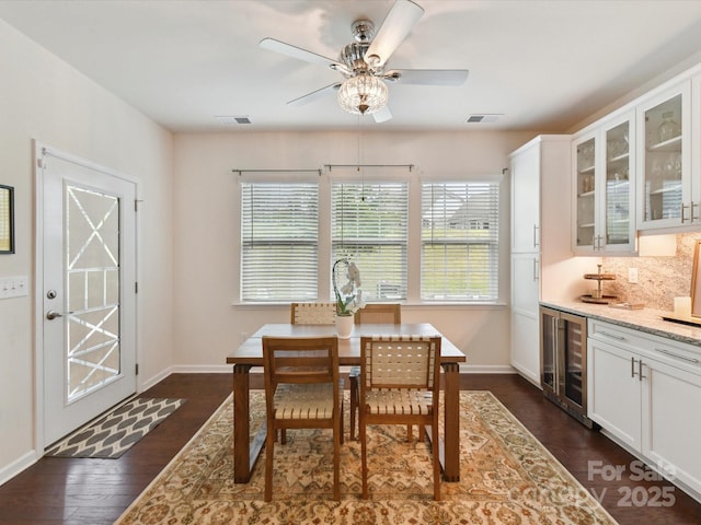 8035 Pastime Ln, Clover, SC 29710 - dining area featuring beverage cooler, ceiling fan, dark wood finished floors, and bar
