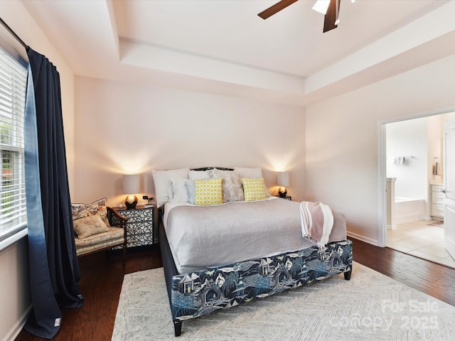 8035 Pastime Ln, Clover, SC 29710 - bedroom with wood finished floors, connected bathroom, a tray ceiling, and ceiling fan