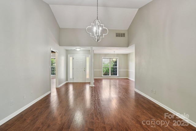 343 Stonehollow Rd, Fletcher, NC 28732 - foyer entrance with a chandelier, high vaulted ceiling, wood finished floors, and decorative columns