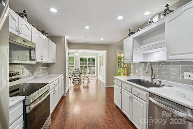 343 Stonehollow Rd, Fletcher, NC 28732 - kitchen featuring stainless steel appliances, ceiling fan, white cabinetry, dark wood-style flooring, and tasteful backsplash