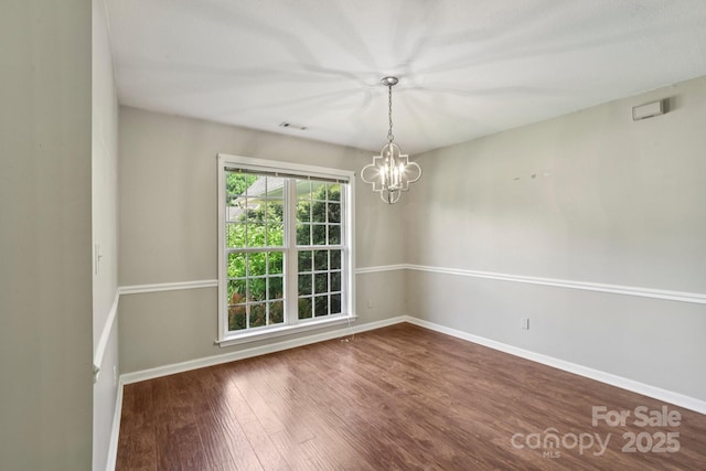 343 Stonehollow Rd, Fletcher, NC 28732 - unfurnished room featuring a chandelier and wood finished floors