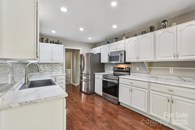 343 Stonehollow Rd, Fletcher, NC 28732 - kitchen featuring appliances with stainless steel finishes, white cabinetry, tasteful backsplash, recessed lighting, and dark wood-type flooring