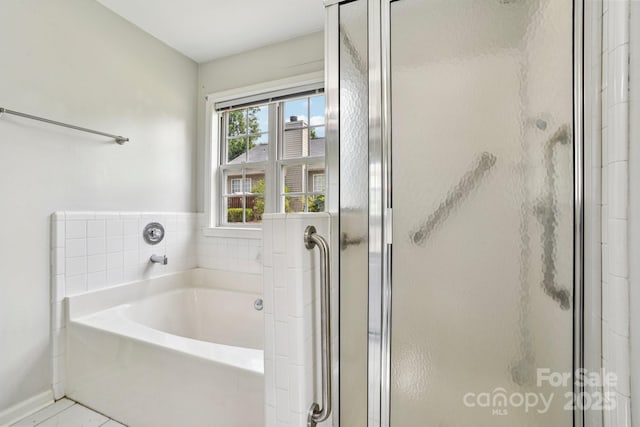343 Stonehollow Rd, Fletcher, NC 28732 - bathroom featuring a garden tub, a stall shower, and tile patterned floors