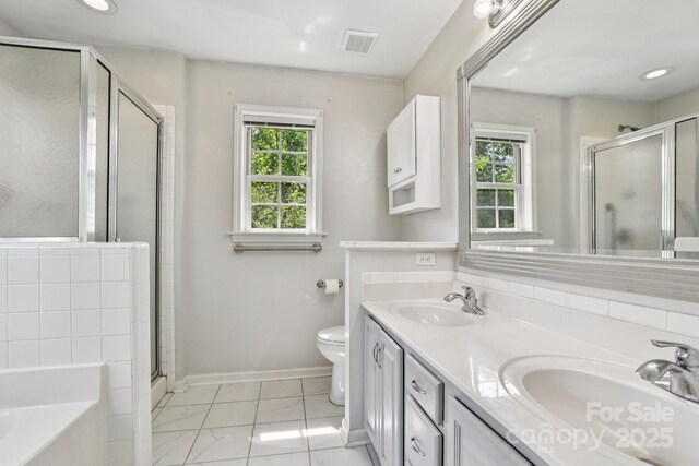 343 Stonehollow Rd, Fletcher, NC 28732 - full bathroom featuring a shower stall, double vanity, a garden tub, and recessed lighting