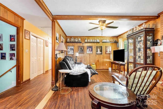 19924 Floral Ln, Cornelius, NC 28031 - living room featuring wood finished floors, wooden walls, ceiling fan, a textured ceiling, and beamed ceiling