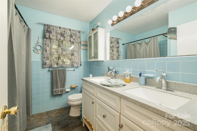19924 Floral Ln, Cornelius, NC 28031 - bathroom with tile walls, double vanity, a shower with shower curtain, and stone finish floors