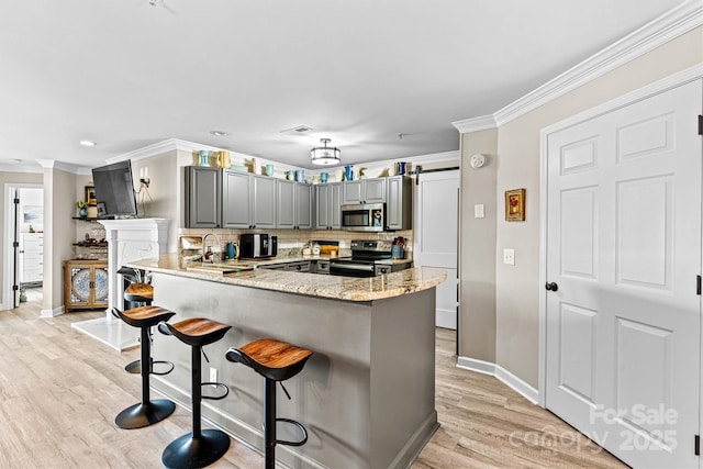 860 Jetton St Unit 59, Davidson, NC 28036 - kitchen featuring stainless steel microwave, electric range, gray cabinetry, ornamental molding, and light wood-style flooring