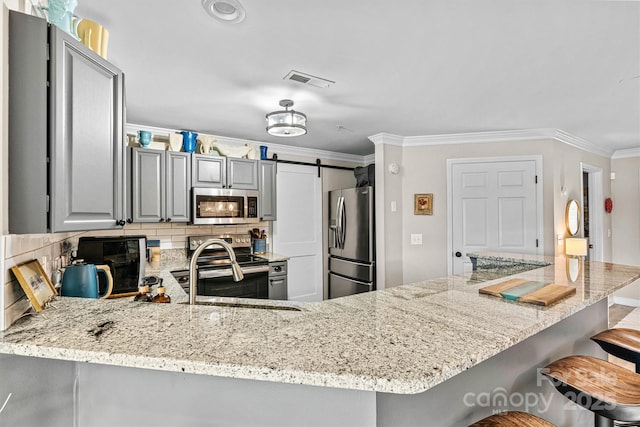 860 Jetton St Unit 59, Davidson, NC 28036 - kitchen featuring appliances with stainless steel finishes, decorative backsplash, gray cabinetry, crown molding, and light stone countertops