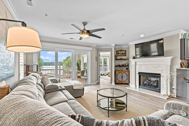 860 Jetton St Unit 59, Davidson, NC 28036 - living area with ceiling fan, ornamental molding, a premium fireplace, light wood-style floors, and recessed lighting