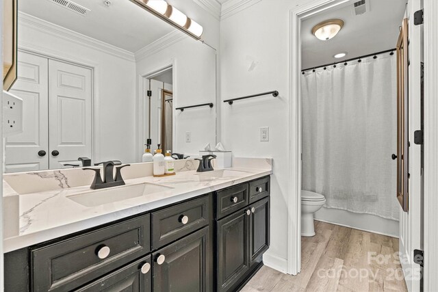 860 Jetton St Unit 59, Davidson, NC 28036 - bathroom featuring double vanity, wood finished floors, ornamental molding, and shower / bathtub combination with curtain