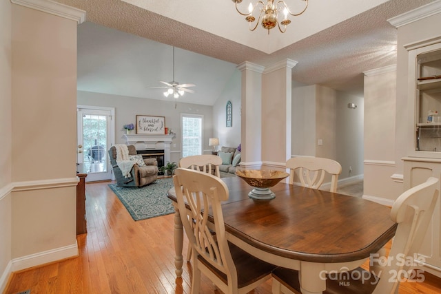 1 Loggerhead Dr, Columbia, SC 29229 - dining area featuring light wood-style floors, ornate columns, a ceiling fan, baseboards, and a textured ceiling