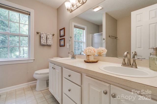 1 Loggerhead Dr, Columbia, SC 29229 - full bath featuring double vanity, toilet, a shower with shower door, tile patterned floors, and baseboards