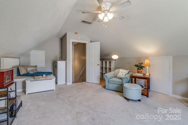 1 Loggerhead Dr, Columbia, SC 29229 - living area featuring a textured ceiling, vaulted ceiling, carpet flooring, ceiling fan, and baseboards