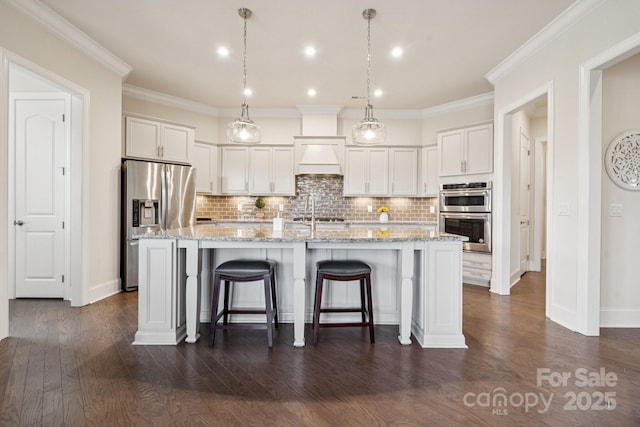 12410 Franklin Park Ln, Huntersville, NC 28078 - kitchen with appliances with stainless steel finishes, backsplash, white cabinets, an island with sink, and a kitchen bar
