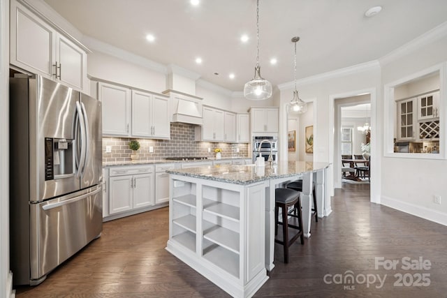 12410 Franklin Park Ln, Huntersville, NC 28078 - kitchen featuring appliances with stainless steel finishes, ornamental molding, open shelves, tasteful backsplash, and a center island with sink