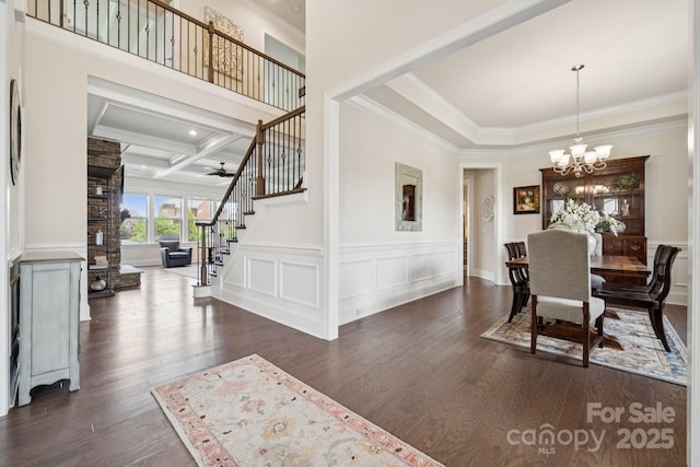 12410 Franklin Park Ln, Huntersville, NC 28078 - dining room with stairs, ornamental molding, a chandelier, dark wood-style flooring, and coffered ceiling