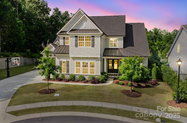 15103 Cimarron Hills Ln, Charlotte, NC 28278 - view of front of house with a standing seam roof, a lawn, roof with shingles, metal roof, and french doors