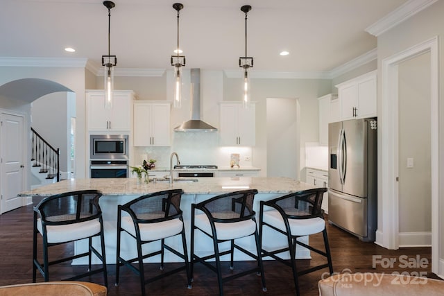 15103 Cimarron Hills Ln, Charlotte, NC 28278 - kitchen with appliances with stainless steel finishes, wall chimney exhaust hood, a sink, decorative backsplash, and white cabinetry