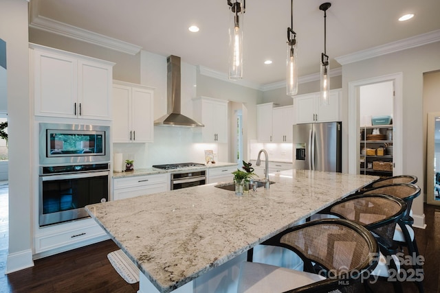 15103 Cimarron Hills Ln, Charlotte, NC 28278 - kitchen featuring stainless steel appliances, wall chimney exhaust hood, a sink, a kitchen breakfast bar, and a center island with sink