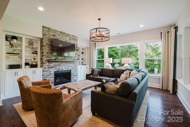 15103 Cimarron Hills Ln, Charlotte, NC 28278 - living room with plenty of natural light, dark wood-style floors, a chandelier, a stone fireplace, and recessed lighting