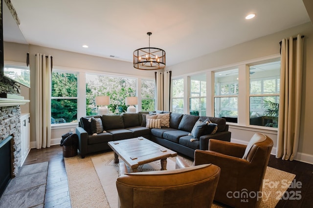 15103 Cimarron Hills Ln, Charlotte, NC 28278 - living room featuring a chandelier, a fireplace, dark wood-type flooring, recessed lighting, and baseboards