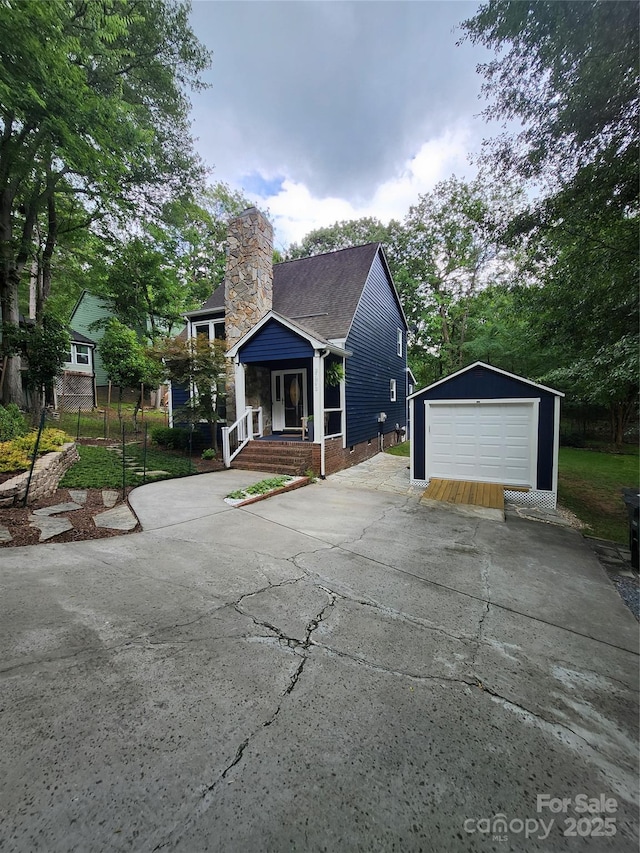 27092 Village Dr, Tega Cay, SC 29708 - view of front of home with a chimney, an outbuilding, a detached garage, and driveway