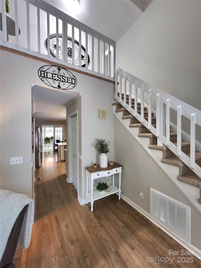 27092 Village Dr, Tega Cay, SC 29708 - stairway featuring wood finished floors and a high ceiling