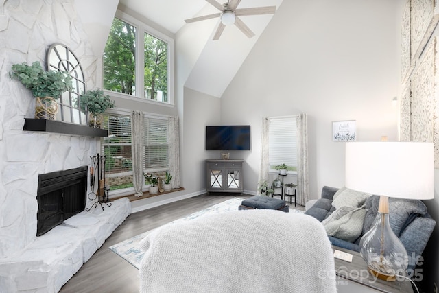 27092 Village Dr, Tega Cay, SC 29708 - living room featuring high vaulted ceiling, ceiling fan, wood finished floors, and a stone fireplace
