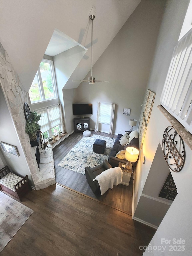 27092 Village Dr, Tega Cay, SC 29708 - living area with high vaulted ceiling, wood finished floors, a ceiling fan, and a stone fireplace