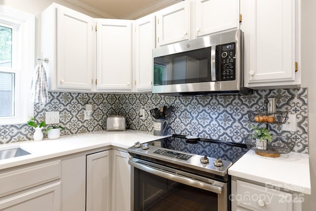 27092 Village Dr, Tega Cay, SC 29708 - kitchen featuring appliances with stainless steel finishes, white cabinetry, and tasteful backsplash