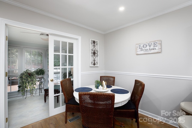 27092 Village Dr, Tega Cay, SC 29708 - dining room featuring french doors, wood finished floors, and crown molding
