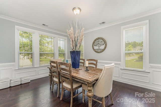 2606 Cheverny Pl, Concord, NC 28027 - dining room featuring crown molding, a decorative wall, a wainscoted wall, and dark wood-style flooring