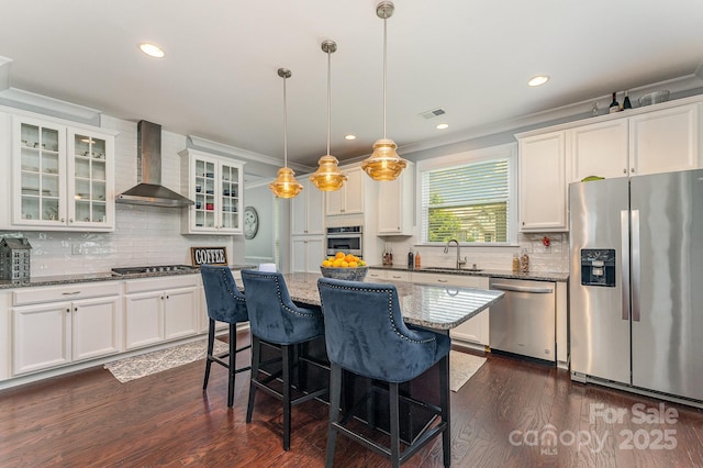 2606 Cheverny Pl, Concord, NC 28027 - kitchen featuring appliances with stainless steel finishes, wall chimney exhaust hood, backsplash, white cabinets, and crown molding