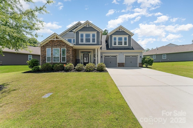 2606 Cheverny Pl, Concord, NC 28027 - craftsman inspired home with concrete driveway, stone siding, a garage, and a front lawn
