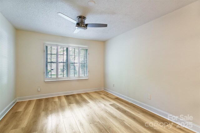 234 Wash Creek Dr Unit B, Hendersonville, NC 28739 - spare room featuring ceiling fan, wood finished floors, and a textured ceiling