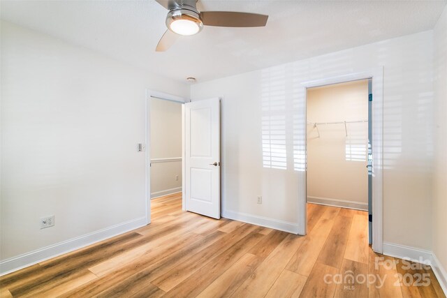 234 Wash Creek Dr Unit B, Hendersonville, NC 28739 - unfurnished bedroom featuring a spacious closet, light wood-style flooring, a closet, and ceiling fan