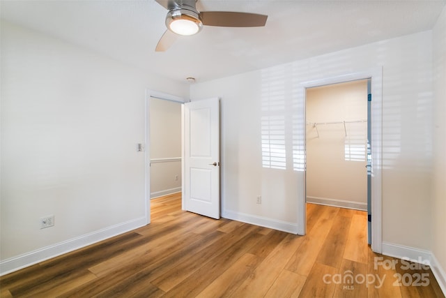 234 Wash Creek Dr Unit B, Hendersonville, NC 28739 - unfurnished bedroom featuring a spacious closet, a closet, light wood finished floors, and a ceiling fan