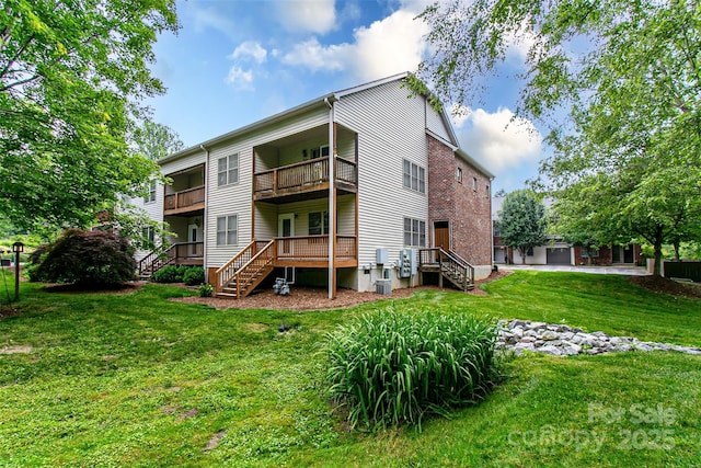 234 Wash Creek Dr Unit B, Hendersonville, NC 28739 - rear view of house with stairway, a balcony, and a yard